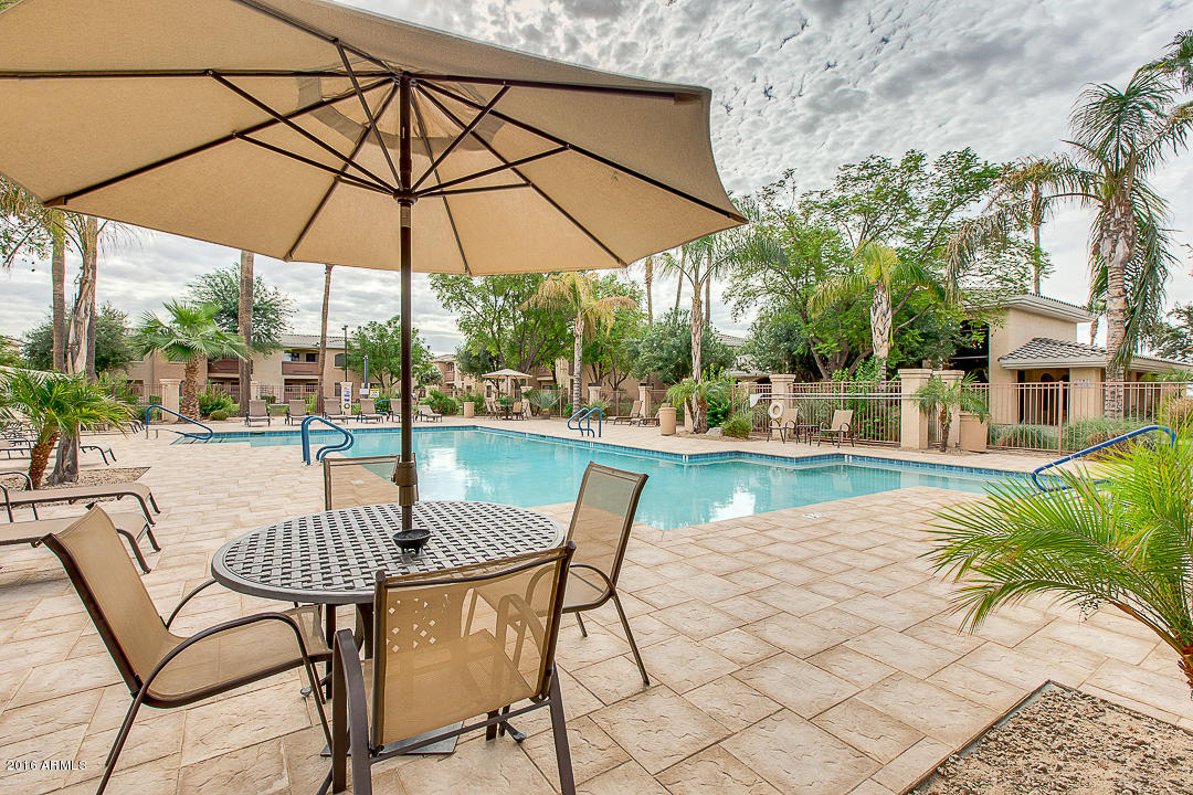 10030 West Indian School Road, Unit 269 Phoenix, AZ 85037 - Photo 32 of 34 a patio with a patio table and chairs