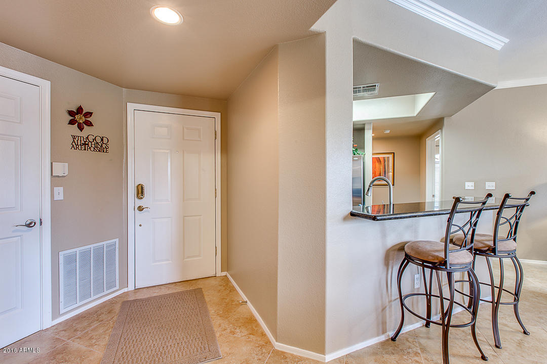 10030 West Indian School Road, Unit 269 Phoenix, AZ 85037 - Photo 4 of 34 a view of dining room with furniture and front door