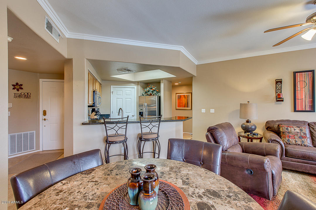 10030 West Indian School Road, Unit 269 Phoenix, AZ 85037 - Photo 5 of 34 a living room with furniture a wooden floor and next to dining table