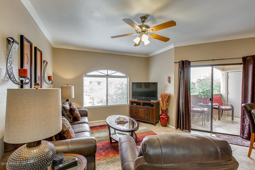 10030 West Indian School Road, Unit 269 Phoenix, AZ 85037 - Photo 7 of 34 a living room with furniture and a flat screen tv