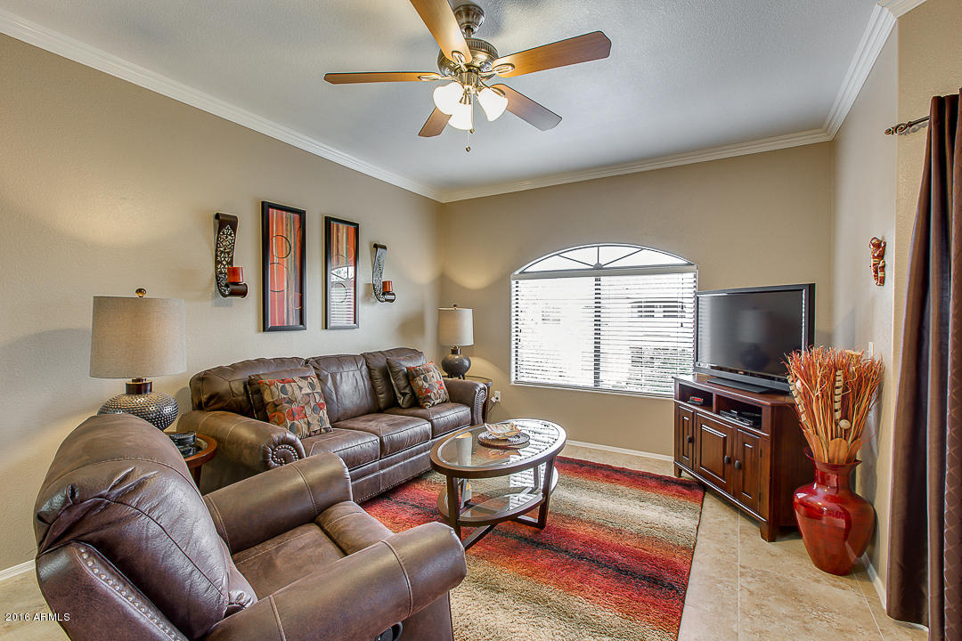 10030 West Indian School Road, Unit 269 Phoenix, AZ 85037 - Photo 8 of 34 a living room with furniture and a flat screen tv