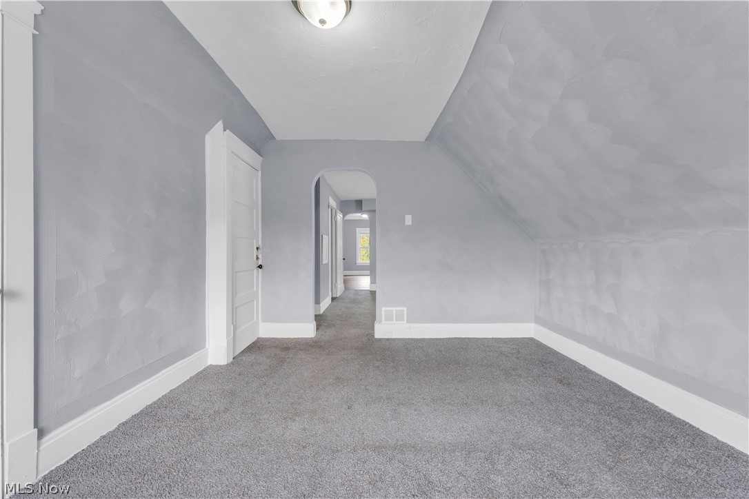 13609 Blenheim Road Cleveland, OH 44110 - Photo 12 of 20 Bonus room featuring carpet floors and lofted ceiling