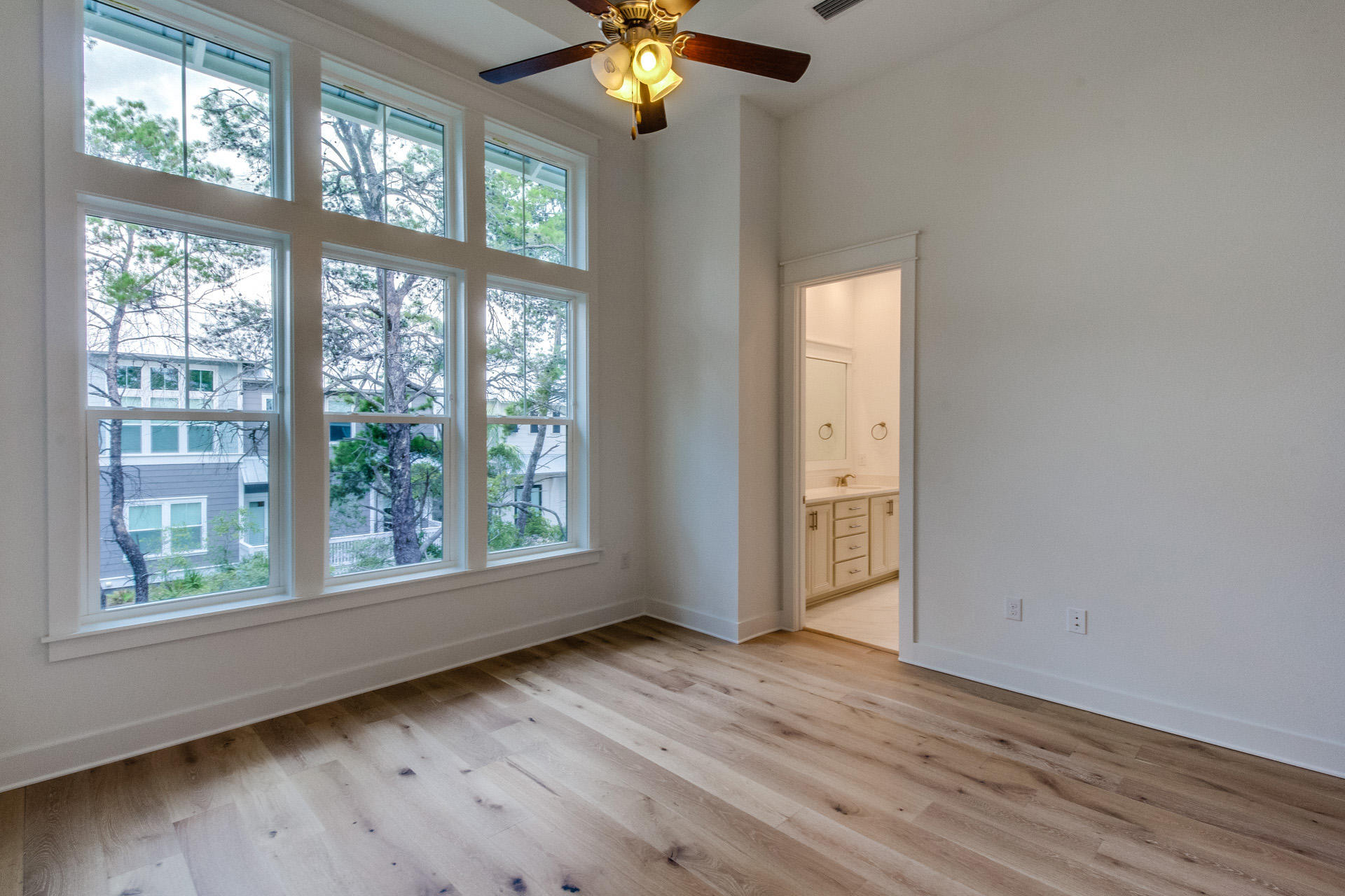 138 Pine Lands Loop Inlet Beach, Unit B Inlet Beach, FL 32461 - Photo 19 of 32 a view of an empty room with wooden floor and a window