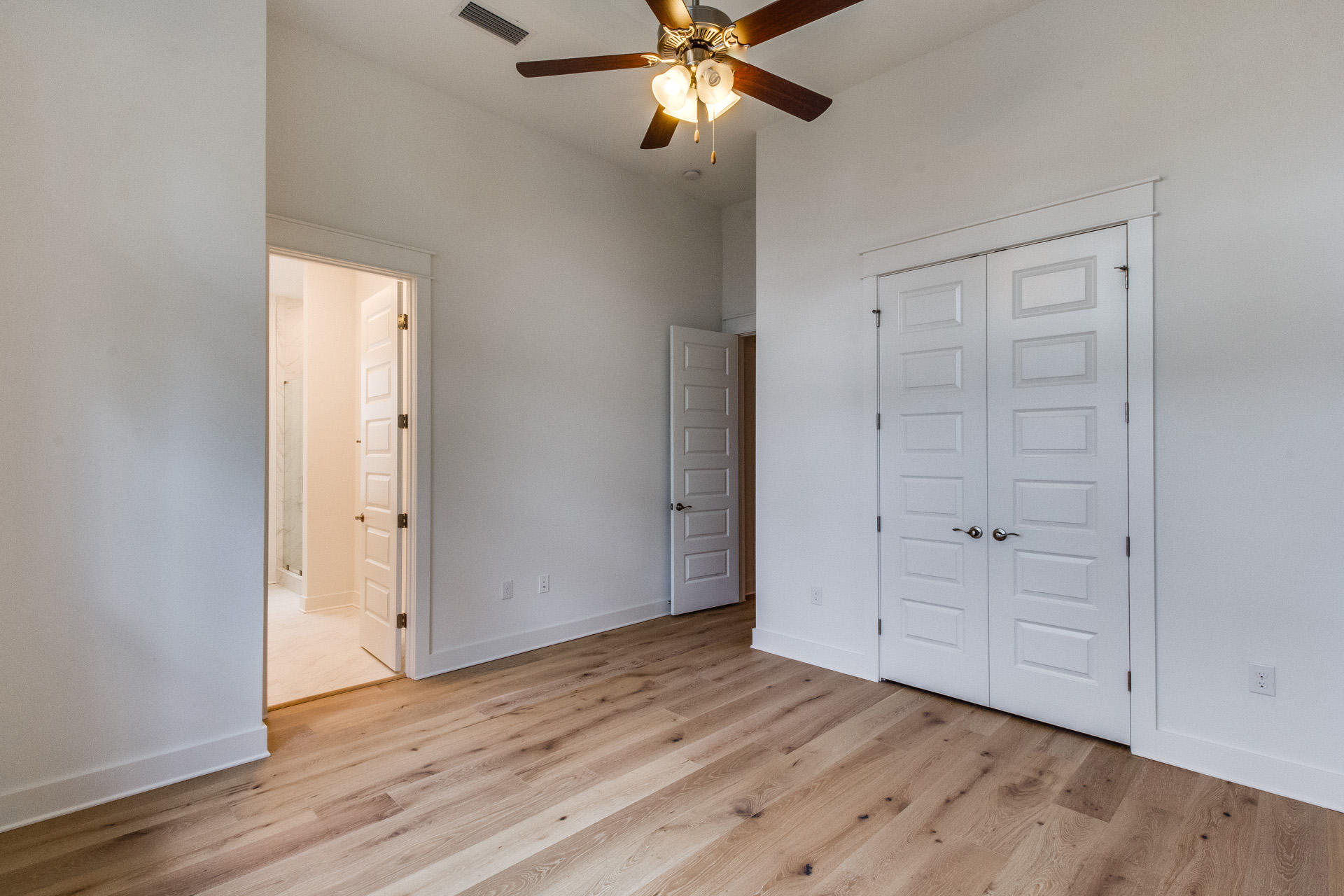 138 Pine Lands Loop Inlet Beach, Unit B Inlet Beach, FL 32461 - Photo 20 of 32 an empty room with wooden floor cabinet and windows