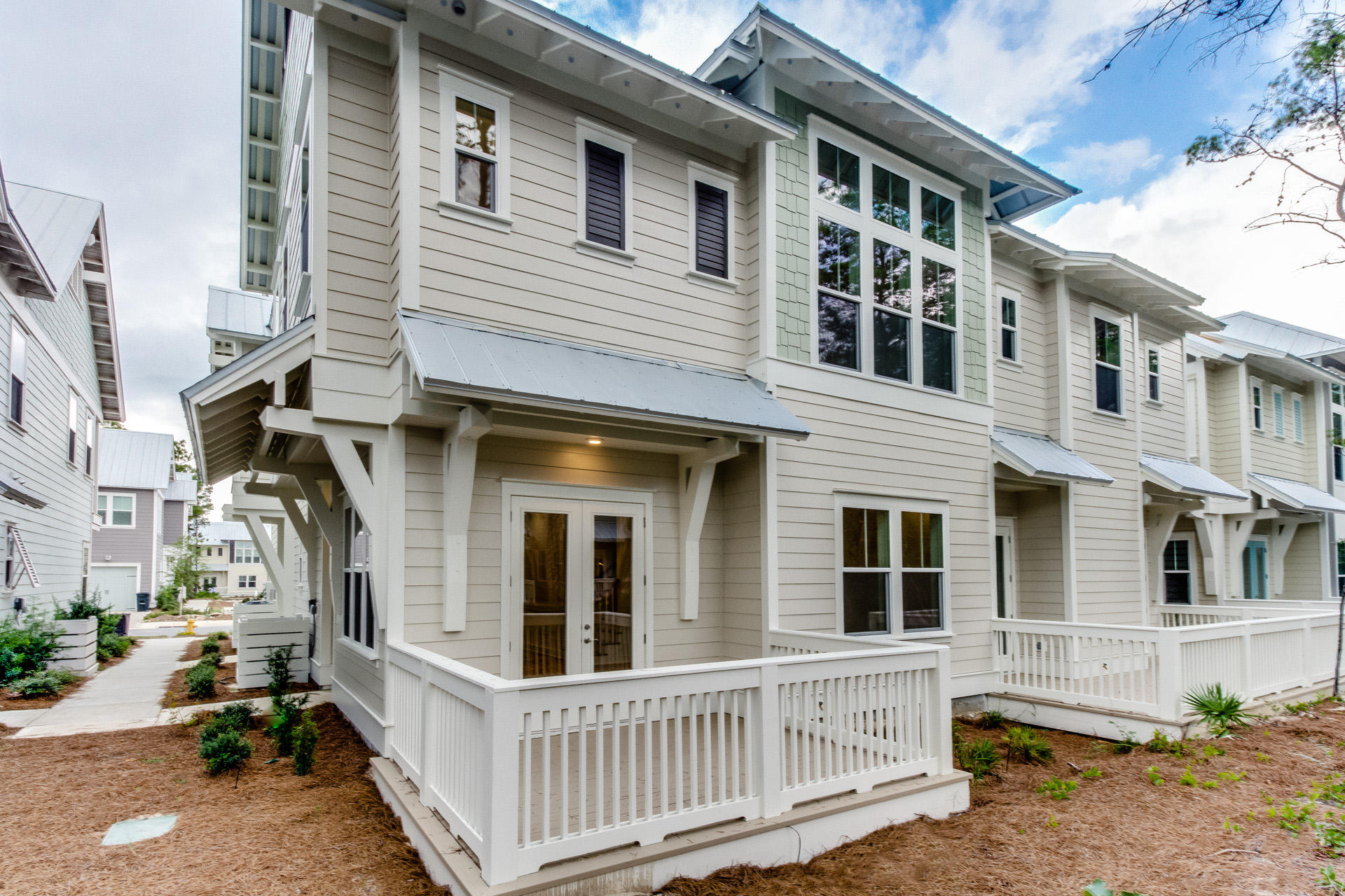 138 Pine Lands Loop Inlet Beach, Unit B Inlet Beach, FL 32461 - Photo 3 of 32 a front view of a house with a yard