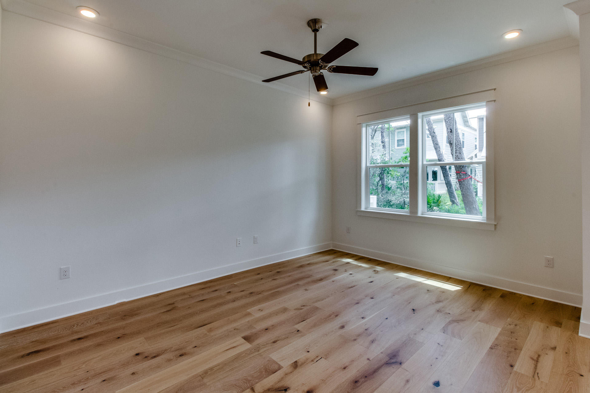 138 Pine Lands Loop Inlet Beach, Unit B Inlet Beach, FL 32461 - Photo 10 of 32 wooden floor in an empty room with a window