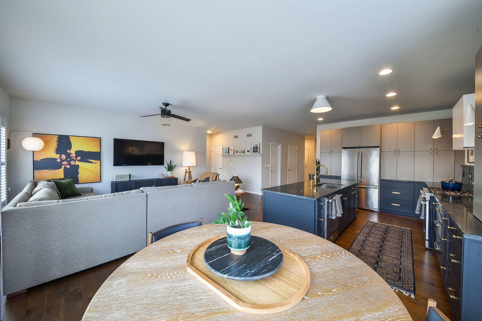 713 Elizabeth Street Elburn, IL 60119 - Photo 14 of 31 a kitchen with stainless steel appliances granite countertop a sink a stove a dining table and chairs with wooden floor