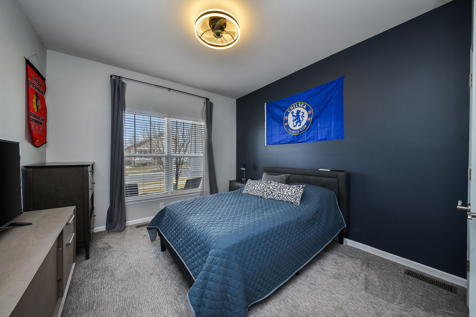 713 Elizabeth Street Elburn, IL 60119 - Photo 17 of 31 a bedroom with a bed and a flat screen tv