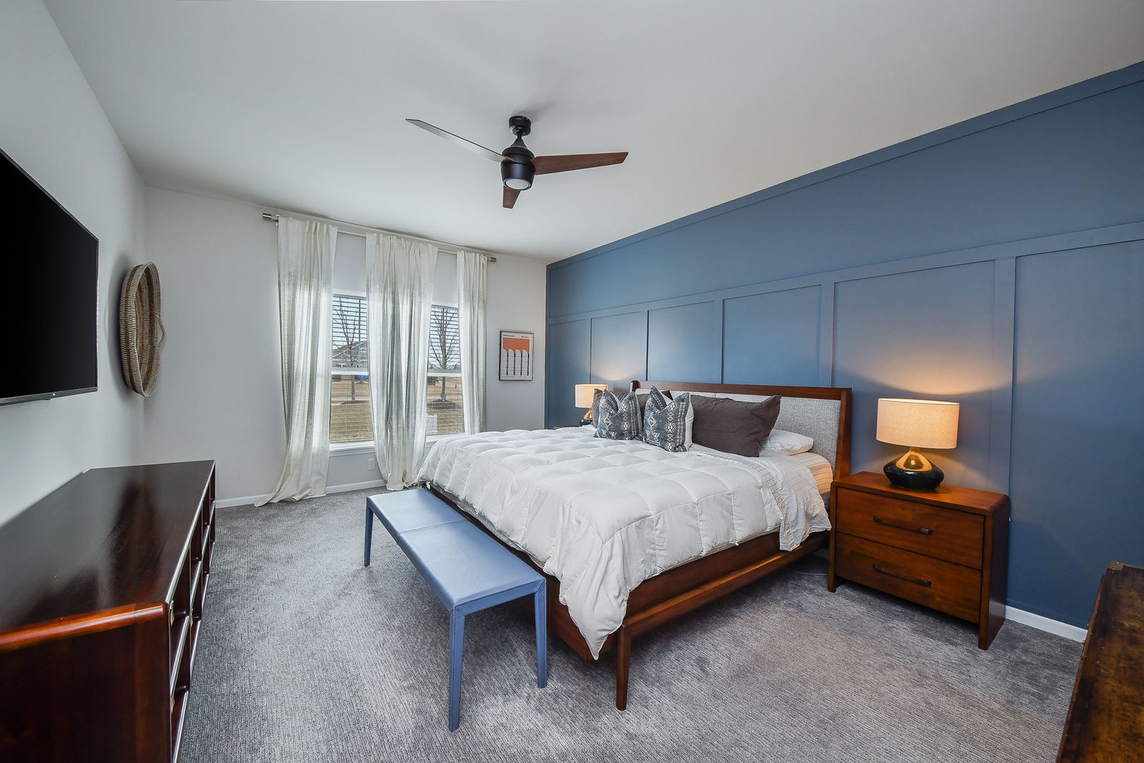 713 Elizabeth Street Elburn, IL 60119 - Photo 19 of 31 a spacious bedroom with a bed a couch and a flat tv screen on a dresser