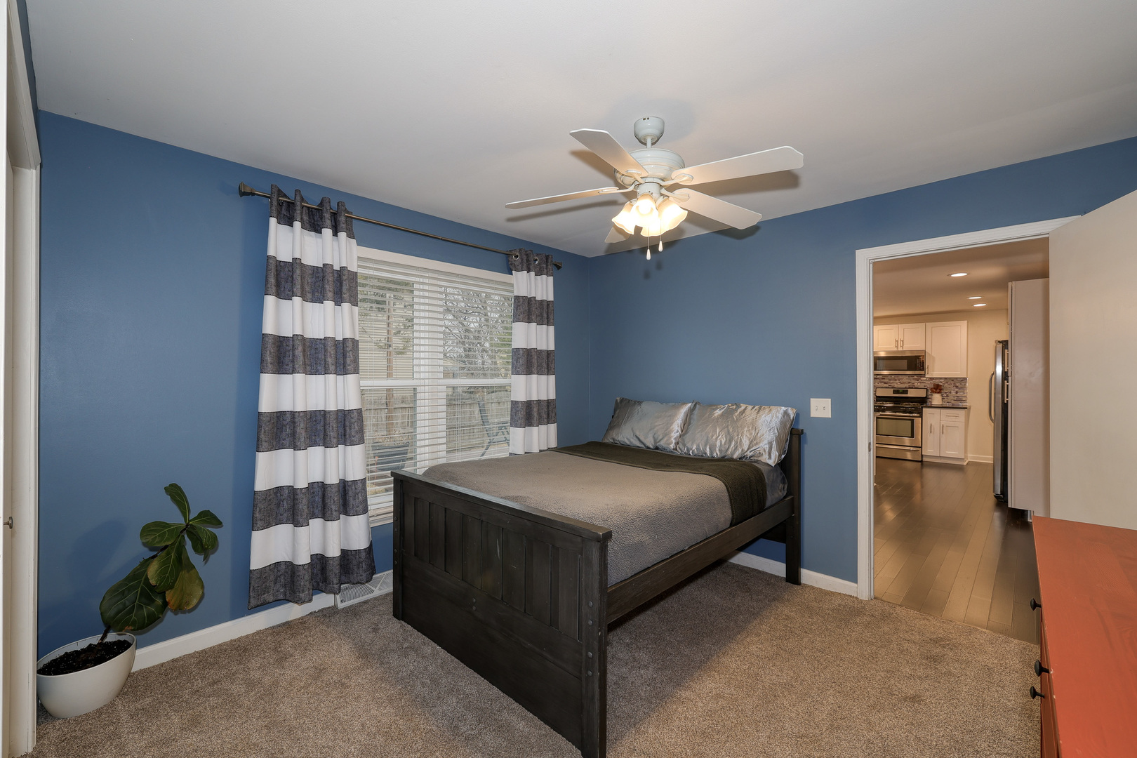 724 South Jefferson Street Batavia, IL 60510 - Photo 10 of 23 a spacious bedroom with a bed and a chandelier