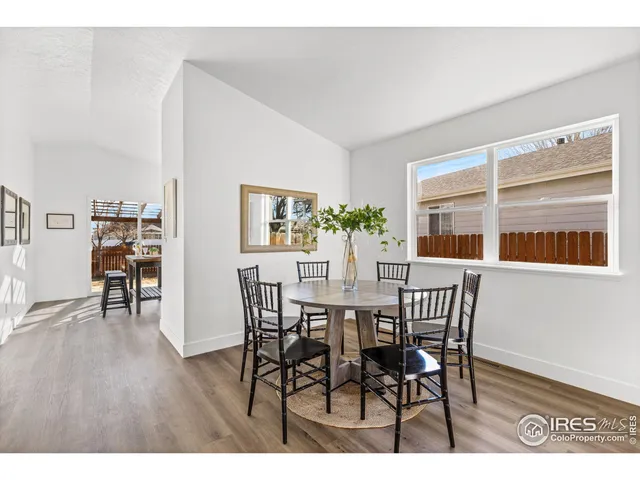 a kitchen with a refrigerator a stove a sink dishwasher and a refrigerator with wooden floor