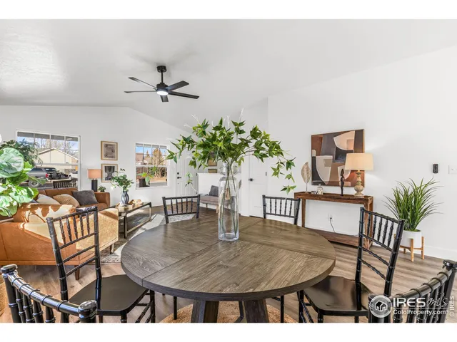a bathroom with a bathtub shower sink vanity mirror and toilet