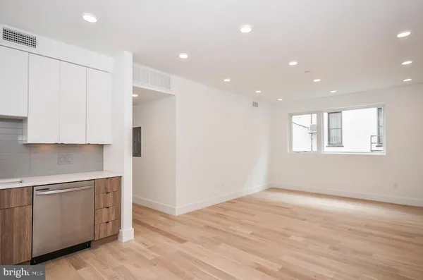a view of an empty room with closet and window