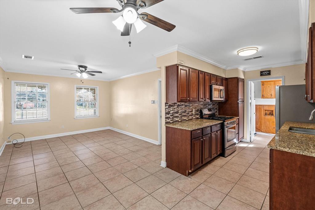 2710 Higgins Drive Shreveport, LA 71104 - Photo 17 of 37 a kitchen with stainless steel appliances granite countertop a stove a sink dishwasher and a refrigerator