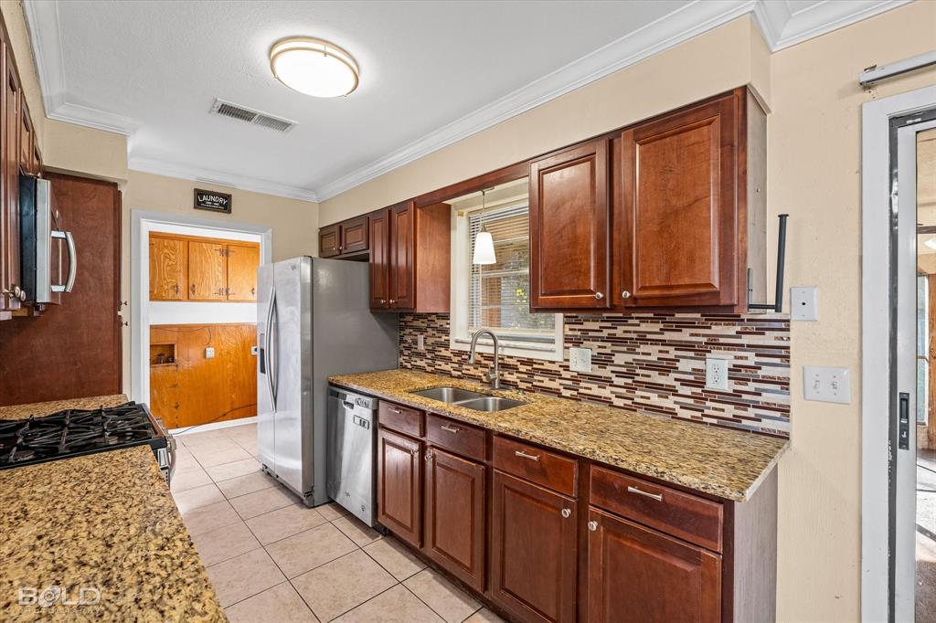 2710 Higgins Drive Shreveport, LA 71104 - Photo 18 of 37 a kitchen with stainless steel appliances granite countertop a stove sink and cabinets