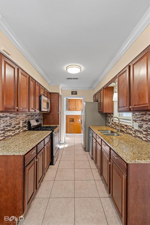 2710 Higgins Drive Shreveport, LA 71104 - Photo 20 of 37 a kitchen with stainless steel appliances granite countertop a stove a sink and a refrigerator