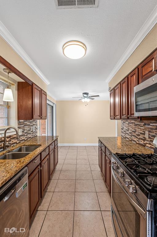 2710 Higgins Drive Shreveport, LA 71104 - Photo 21 of 37 a kitchen with stainless steel appliances granite countertop a stove a sink and a microwave