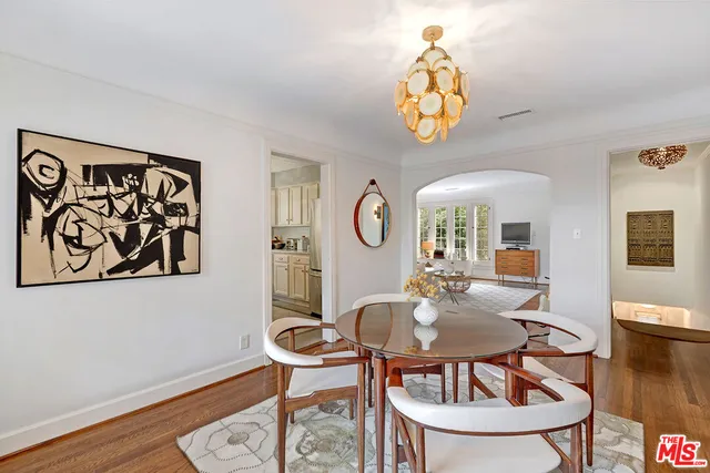 a dining room with furniture and a chandelier