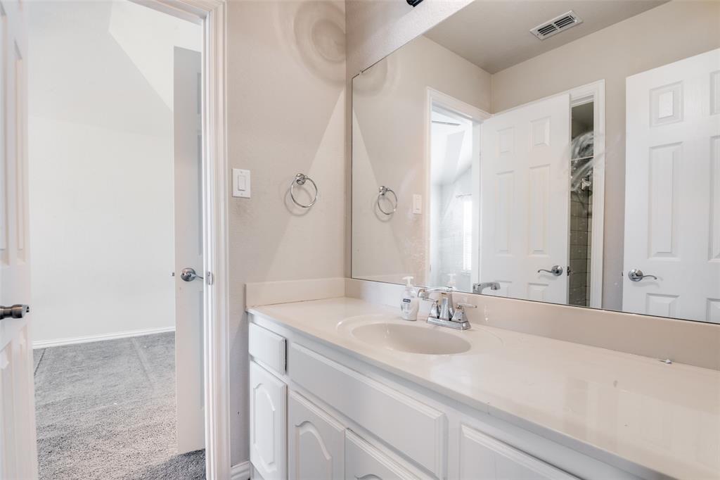 679 Princeton Way Rockwall, TX 75087 - Photo 11 of 25 a bathroom with a sink and a mirror