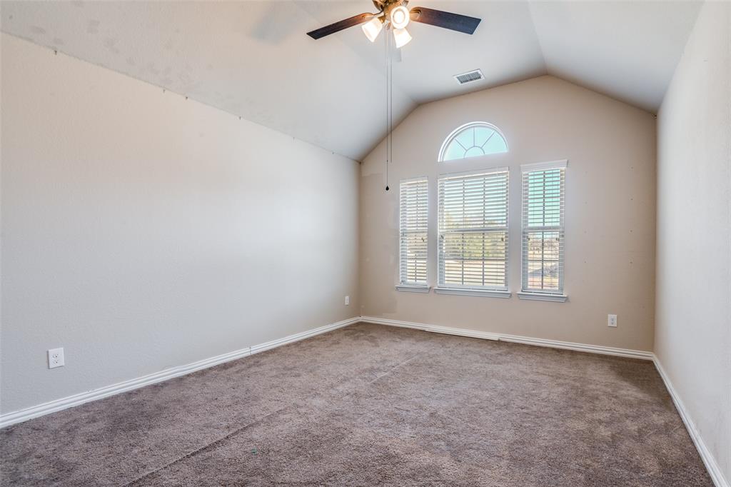 679 Princeton Way Rockwall, TX 75087 - Photo 13 of 25 an empty room with a chandelier fan and windows