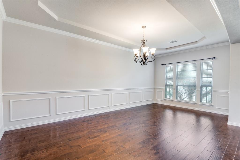 679 Princeton Way Rockwall, TX 75087 - Photo 15 of 25 a view of an empty room with wooden floor and a window