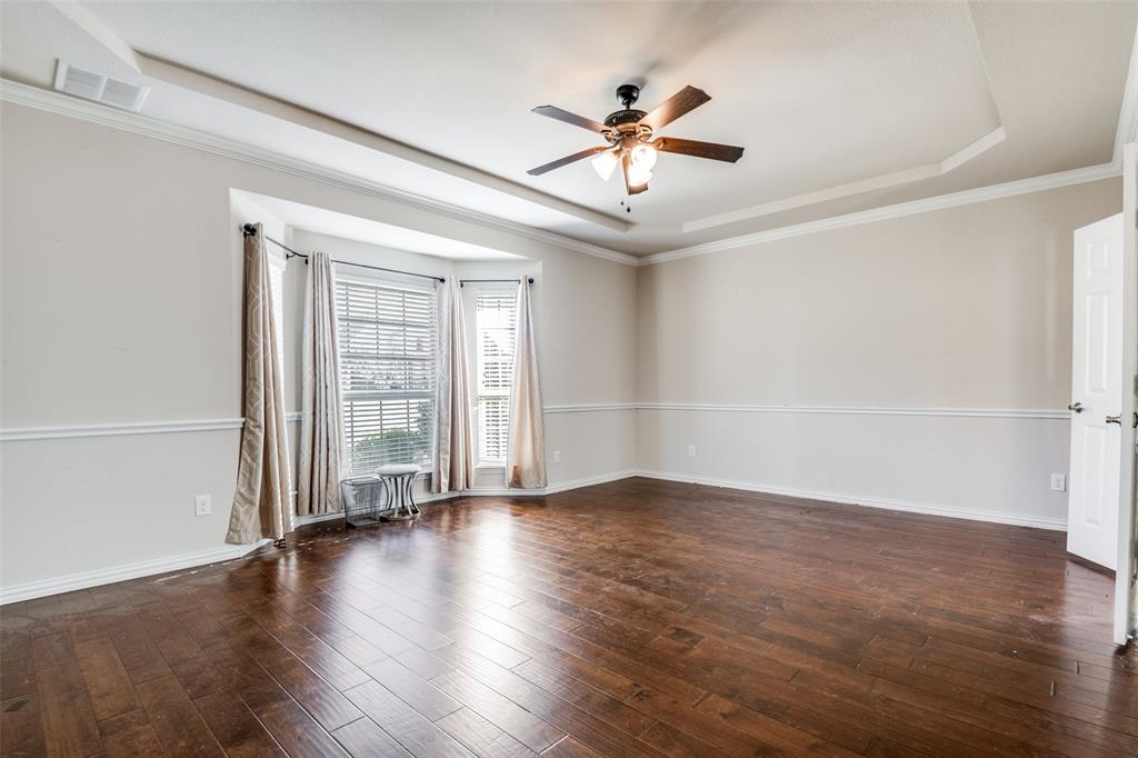 679 Princeton Way Rockwall, TX 75087 - Photo 17 of 25 an empty room with wooden floor fan and windows