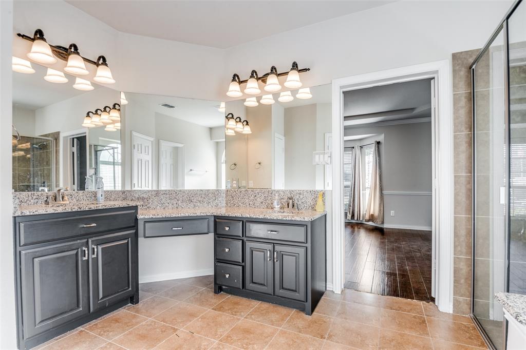 679 Princeton Way Rockwall, TX 75087 - Photo 19 of 25 a spacious bathroom with a granite countertop sink a mirror and a shower