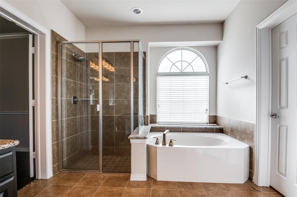 679 Princeton Way Rockwall, TX 75087 - Photo 21 of 25 a bathroom with a bathtub a shower and a window