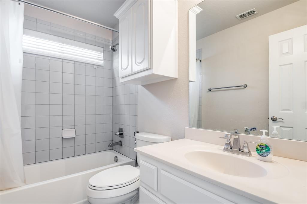 679 Princeton Way Rockwall, TX 75087 - Photo 22 of 25 a bathroom with a sink a toilet and shower