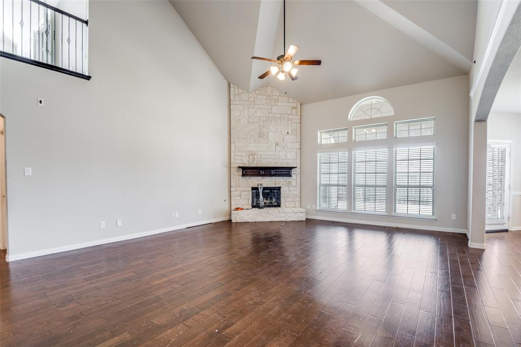 679 Princeton Way Rockwall, TX 75087 - Photo 3 of 25 a view of an empty room with wooden floor and a window