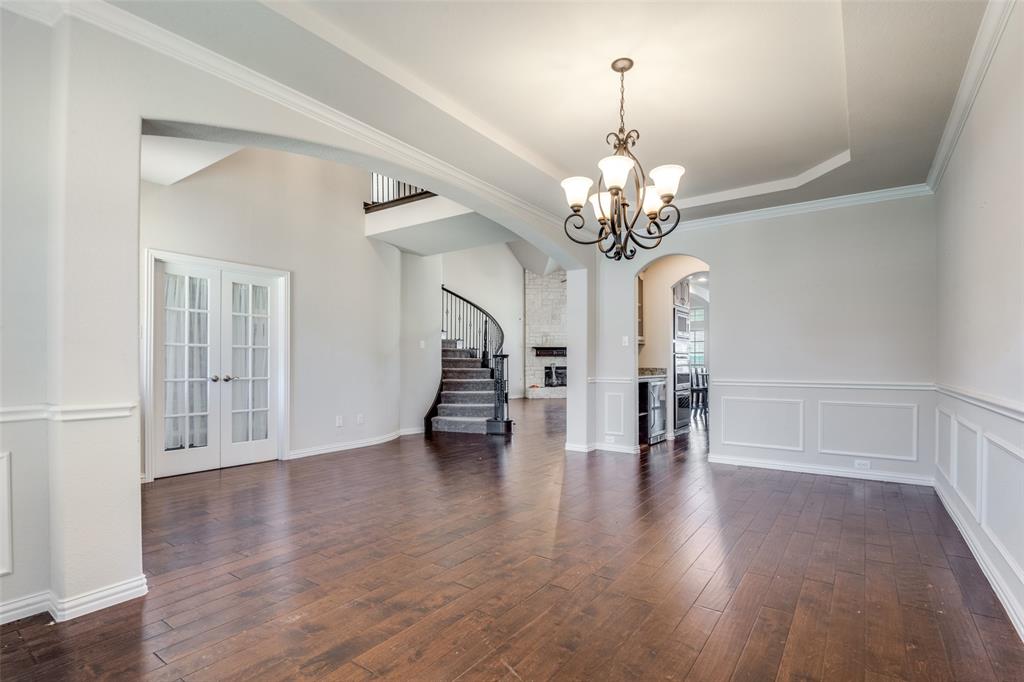 679 Princeton Way Rockwall, TX 75087 - Photo 4 of 25 a view of a livingroom with wooden floor and a chandelier