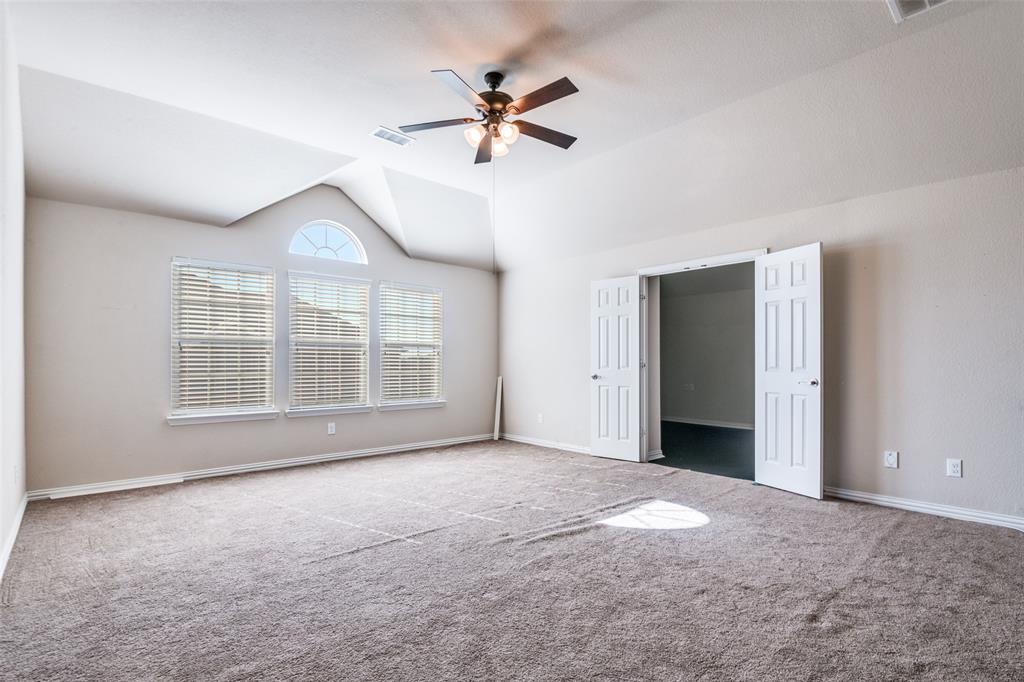 679 Princeton Way Rockwall, TX 75087 - Photo 9 of 25 a view of an empty room with a ceiling fan and window