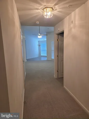 a view of a hallway with a chandelier