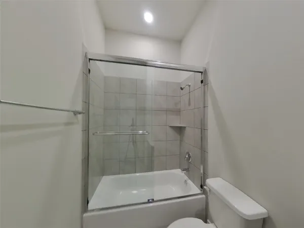 a bathroom with a shower and toilet