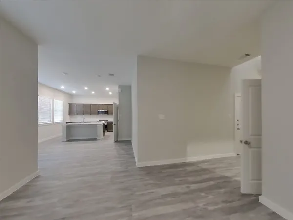 a view of a kitchen with wooden floor and a sink