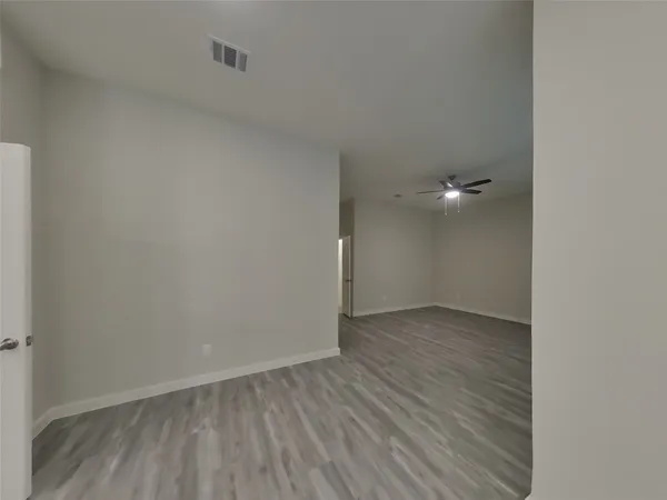 a view of a room with wooden floor