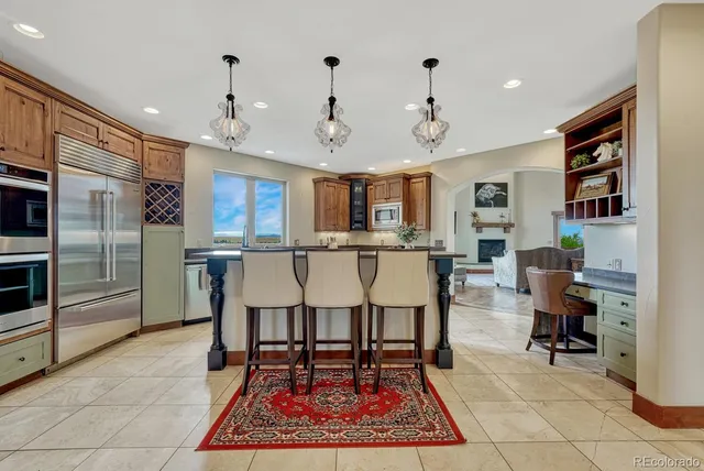 a large kitchen with a table and chairs