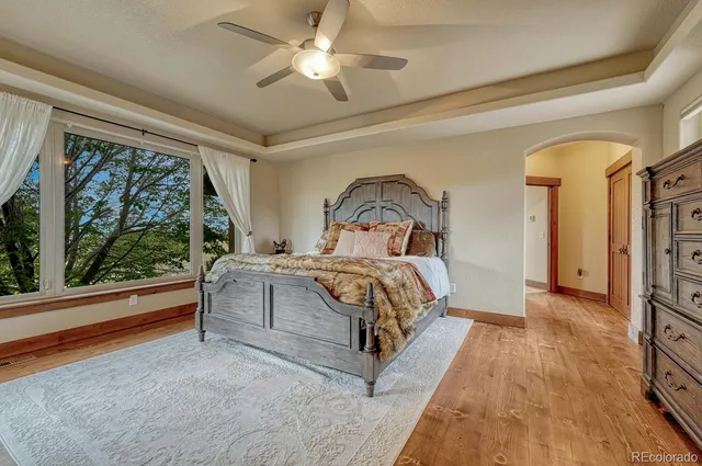 a bedroom with a large bed and a chandelier