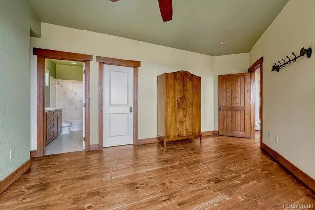 a view of an empty room with closet and a window
