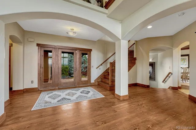 a view of an entryway with wooden floor and a livingroom