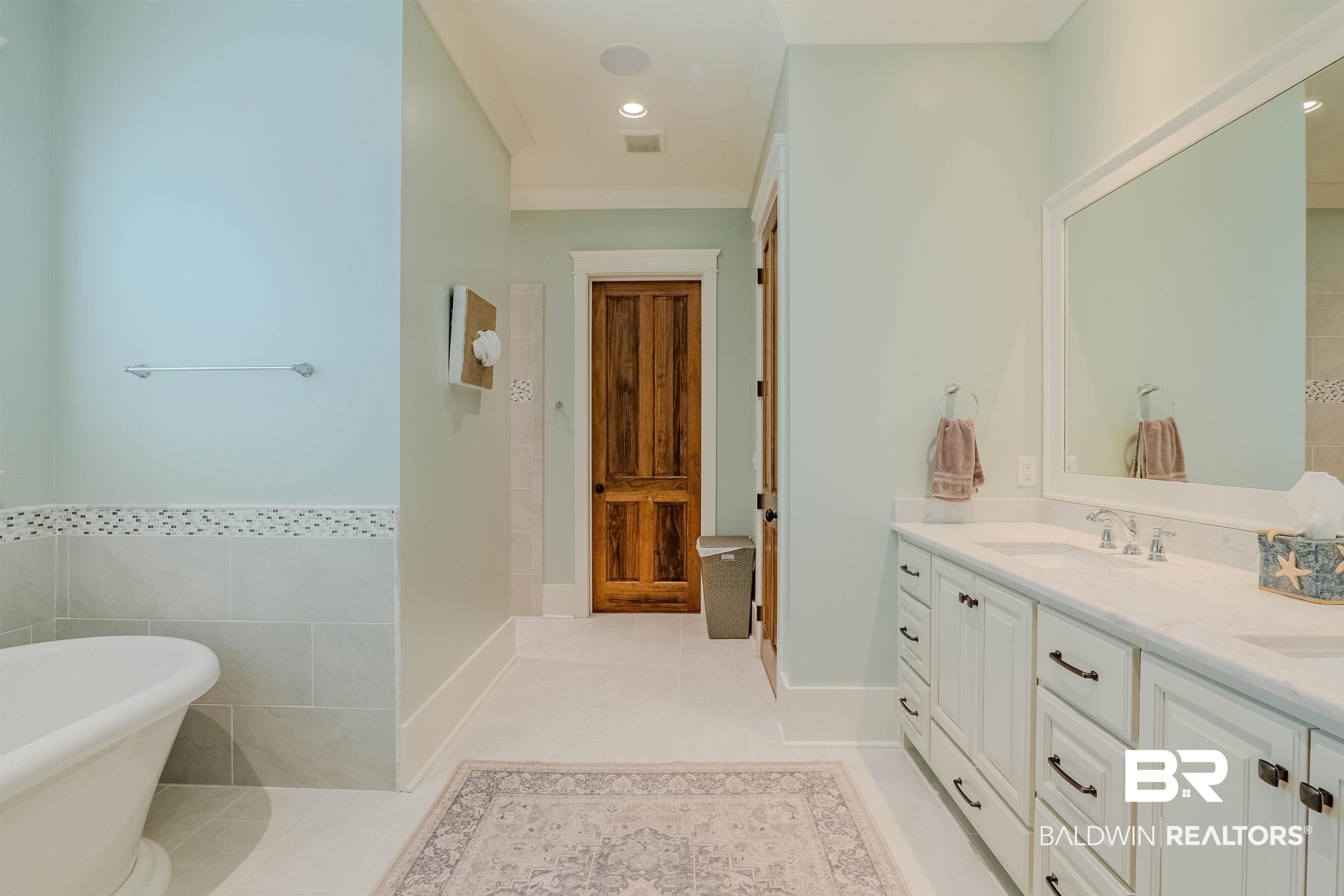 708 Manning Place Fairhope, AL 36532 - Photo 28 of 58 Bathroom with a tub to relax in, tile patterned flooring, vanity, and tile walls
