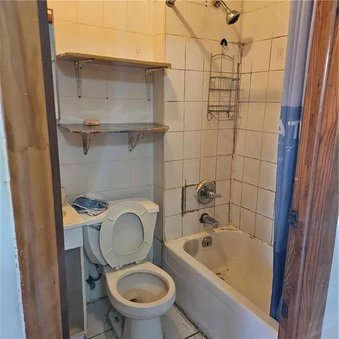 a bathroom with a granite countertop toilet a sink and bathtub