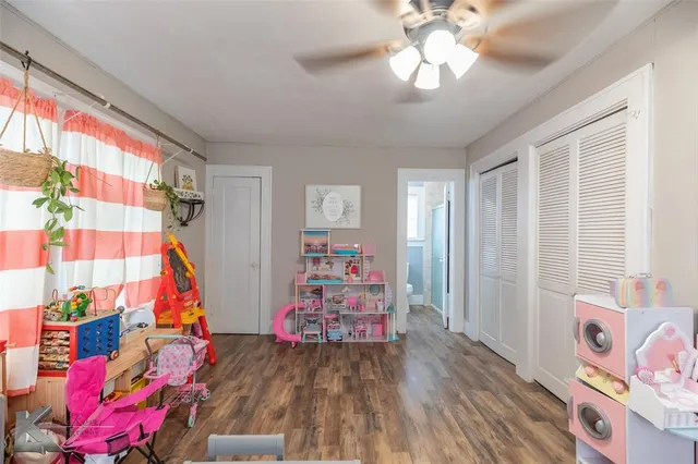 a view of a room with toys and wooden floor