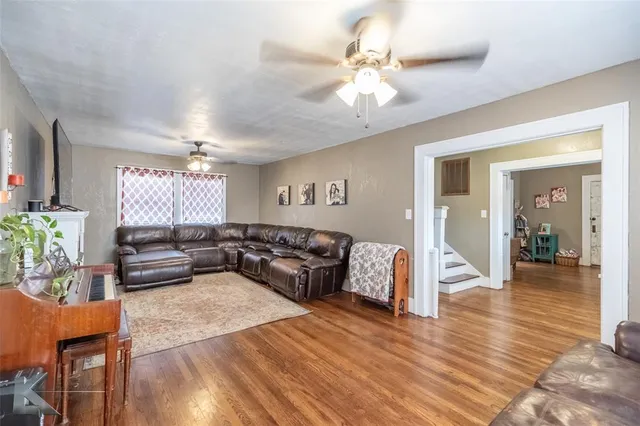 a living room with furniture and wooden floor