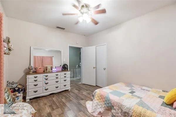 a bedroom with a bed and a dresser