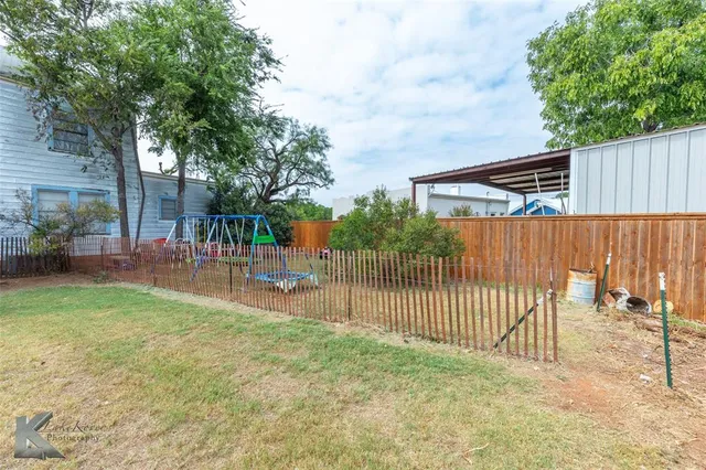 a view of backyard with a garden and deck