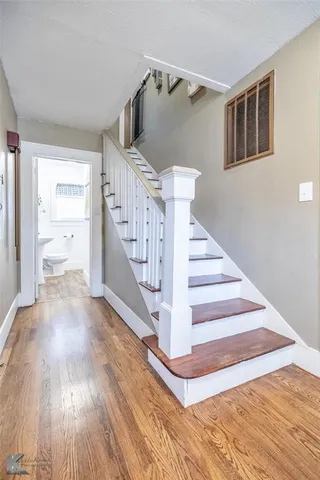 a view of entryway and hall with wooden floor