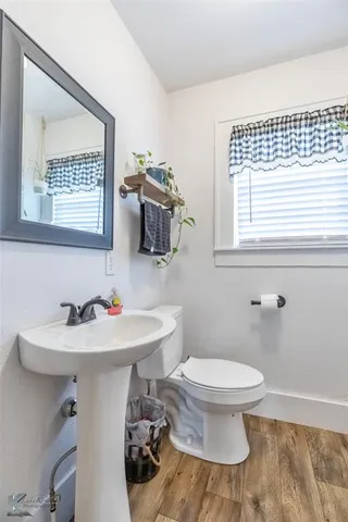 a bathroom with a sink toilet a mirror and shower