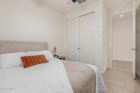 an empty room with wooden floor and closet area