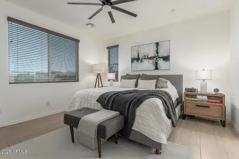 a view of a hallway with wooden floor and a bathroom